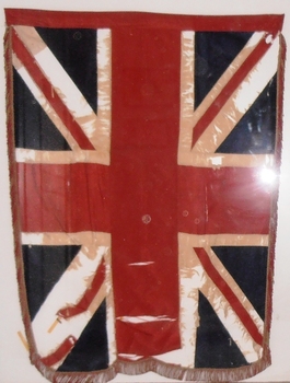 Two very old flags in a wooden case.