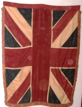 Large flag with fringe around edge.