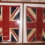 Large glass fronted case with two flags in it.