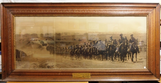 Framed photograph of soldiers on horses.