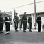 Servicemen formed up for a parade in city street.