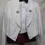 A short jacket with badges on lapels worn with a bow tie.