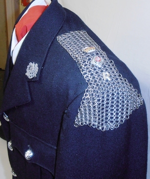 Chain mail on shoulder of jacket.
