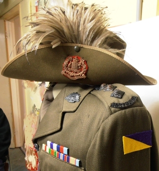 Soldier's uniform and hat with badge and feathers.
