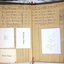Open book showing cards glued to pages