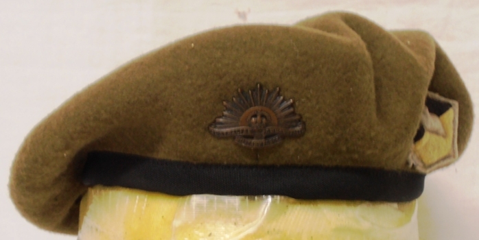 Khaki beret with badge and coloured patch on side.