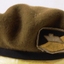 Coloured patch on beret featuring tank.