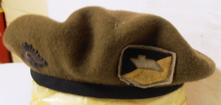Coloured patch on beret featuring tank.