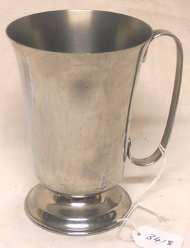 Metal drinking cup with handle.