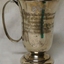 Silver mug with handle, inscribed on two sides.