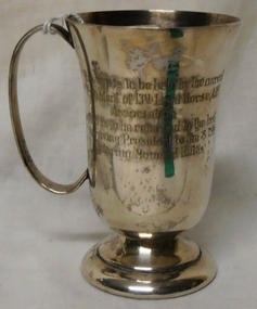 Silver mug with handle, inscribed on two sides.