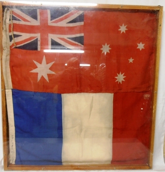 Two flags sewn together in frame.