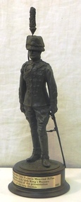 Small sculpture of soldier on wooden base