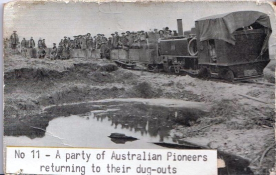 Soldiers crowded on rail wagon.