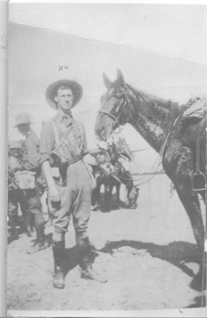 soldier standing with his horse.