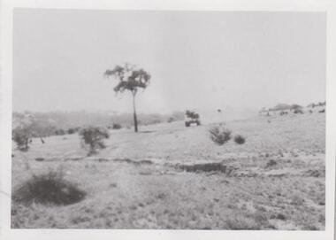 Photograph of tank on a hillside.