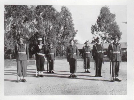Seven servicemen in variety of uniforms