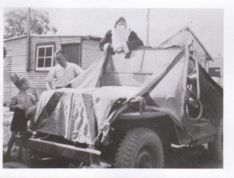Santa Claus in a truck made to look like a sleigh 