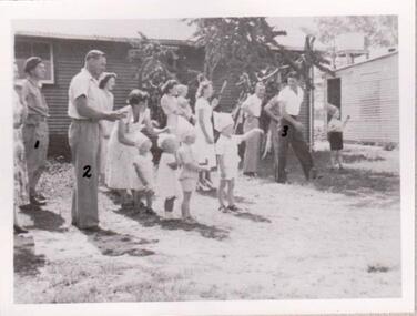 Group of men and women arranging a race for children.