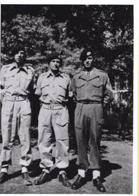 Three soldiers in different uniforms; all wearing berets.