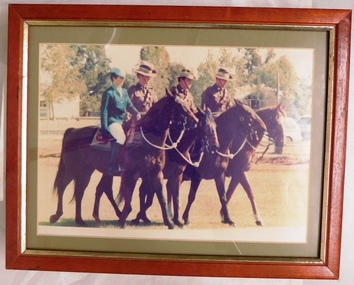 Soldiers, one woman and three men, on horses