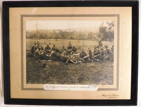 Framed photograph of soldiers relaxing in paddock