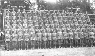 Large group photograph of soldiers wearing caps.