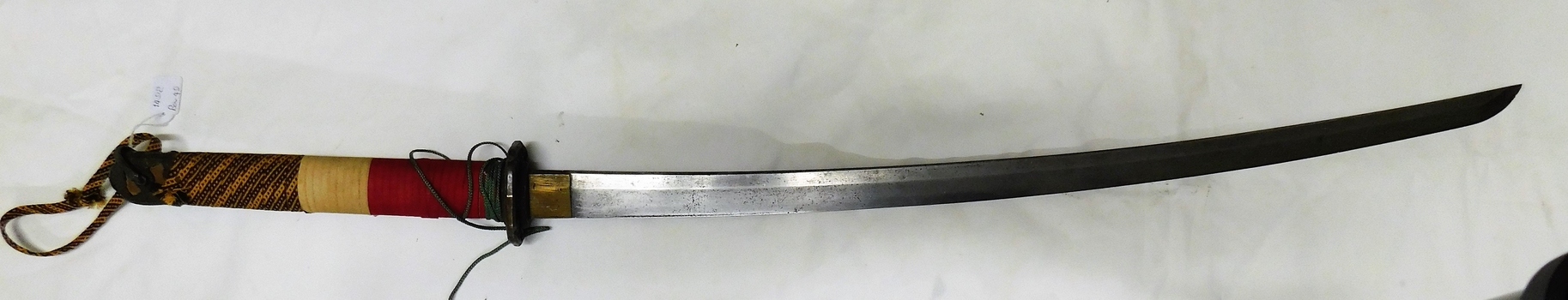 Curved sword with coloured handle.