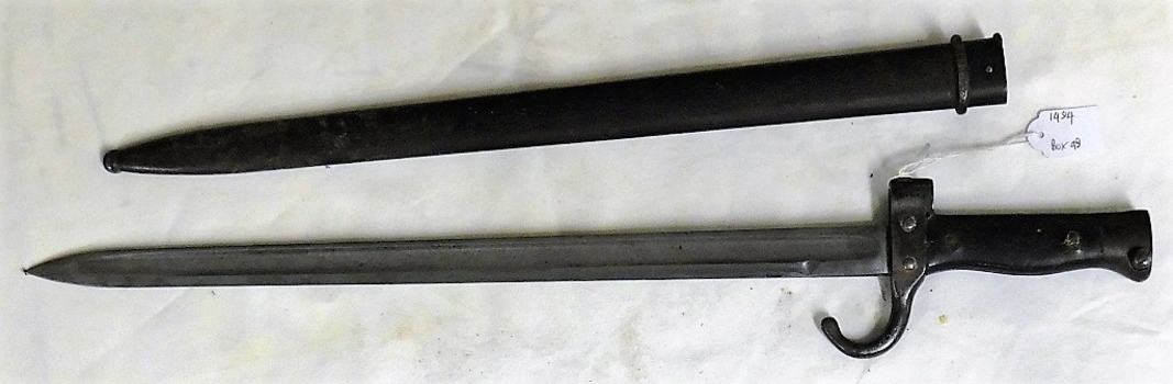 Long metal knife with a carry sheath