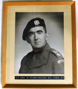 Army officer wearing winter jacket and beret.