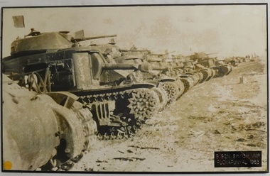 Row of tanks lined up wheel to wheel.
