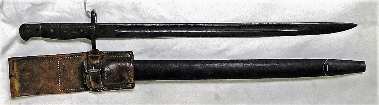 Long knife with leather sheath.