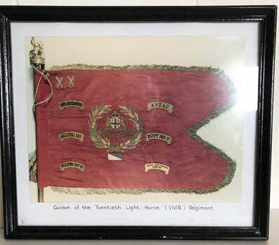 Framed photograph of flag with tag around edges.