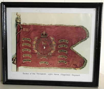 Photograph of flag with tags around edges.