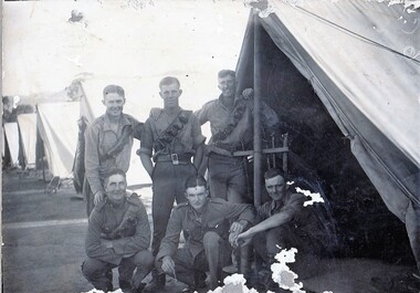 Six soldiers with row of tents.