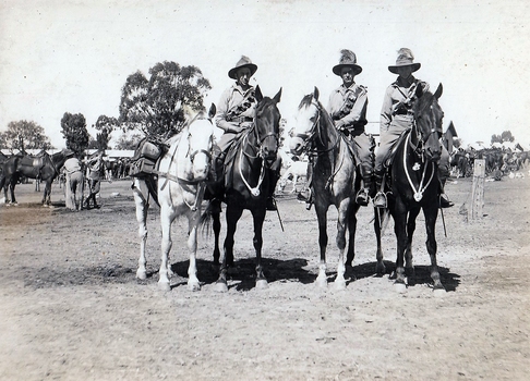 Three soldiers with four horses.