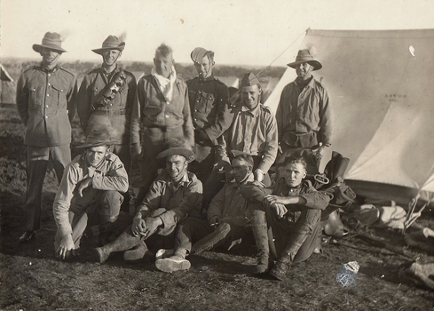 Ten soldiers beside a tent.