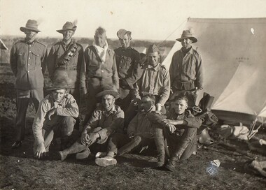 Ten soldiers beside a tent.