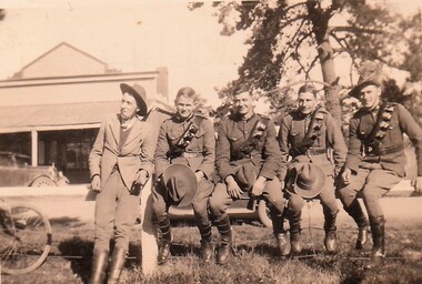Five young men, four in uniform.