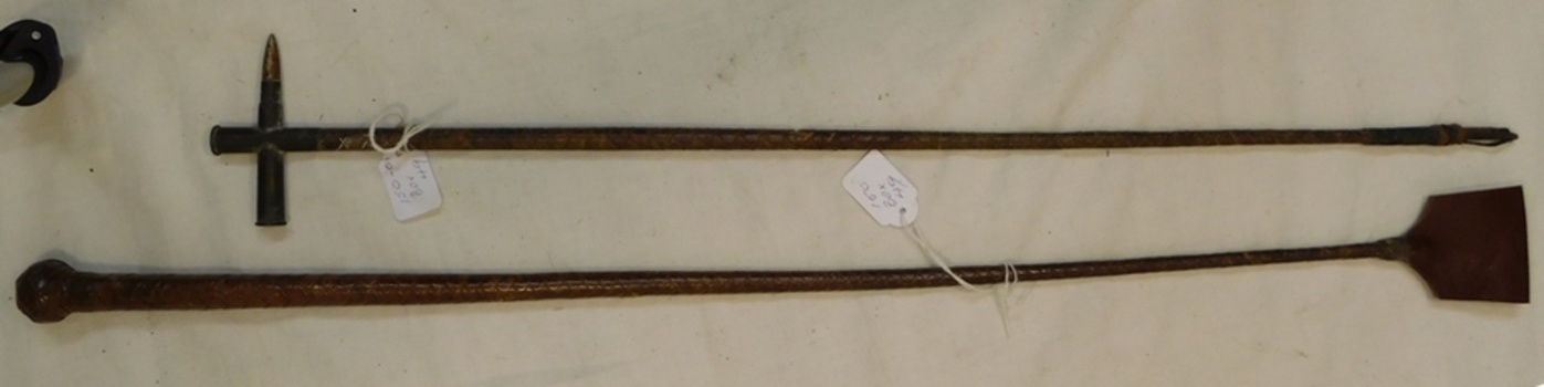Two sticks with decorative leather covering