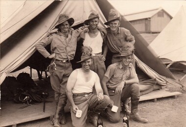 Five happy soldiers outside their tent