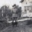 Soldier standing in front of farmhouse