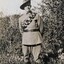 Soldier smiling standing near small tree