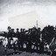 Soldiers on horses near car