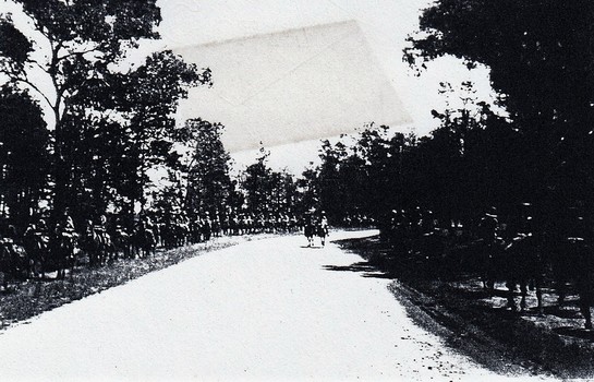 Soldiers on horses alongside road