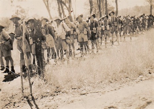 Line of soldiers in shorts and shirts