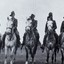 Five soldiers on horses.