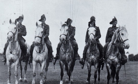 Five soldiers on horses.