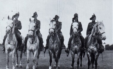 Five soldiers on horses.