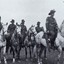 Five soldiers armed with rifles on horses